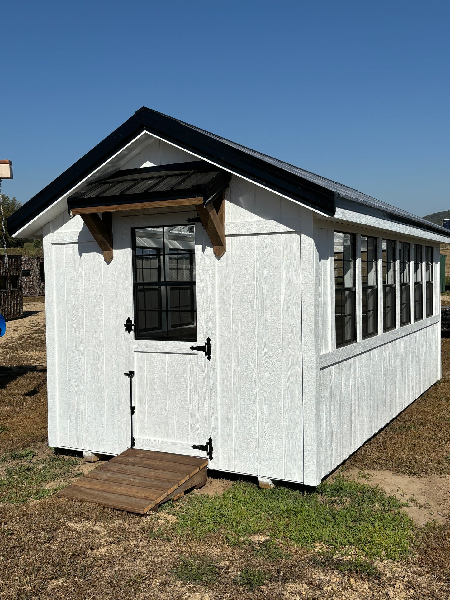 8 x 16 greenhouse white with black windows and timber frame awning and ramp